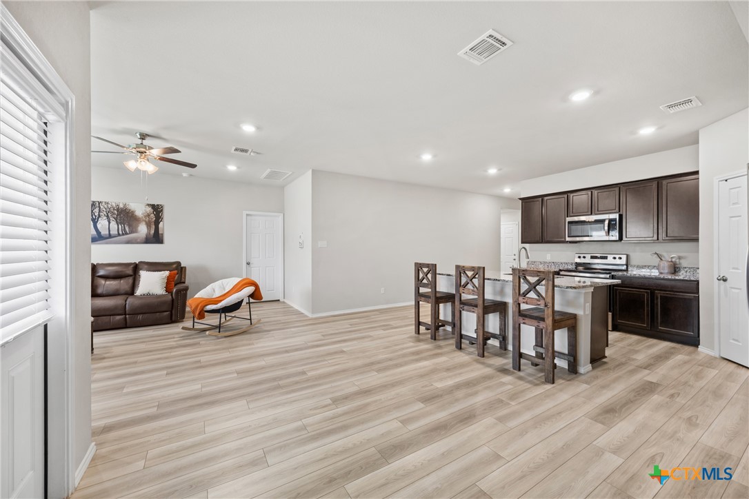 8903 Cantera Rdg Road Temple, TX 76502 - Photo 14 of 25 a living room with stainless steel appliances furniture wooden floor and a kitchen view