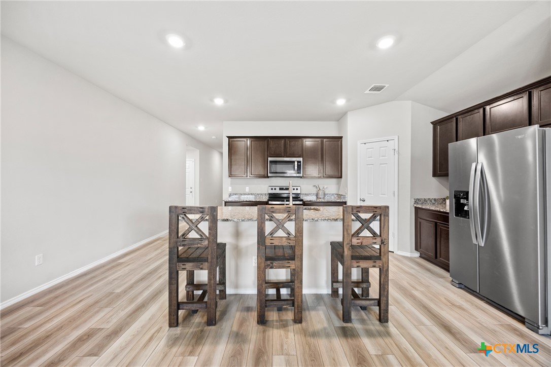 8903 Cantera Rdg Road Temple, TX 76502 - Photo 15 of 25 a view of a dining room with furniture and wooden floor
