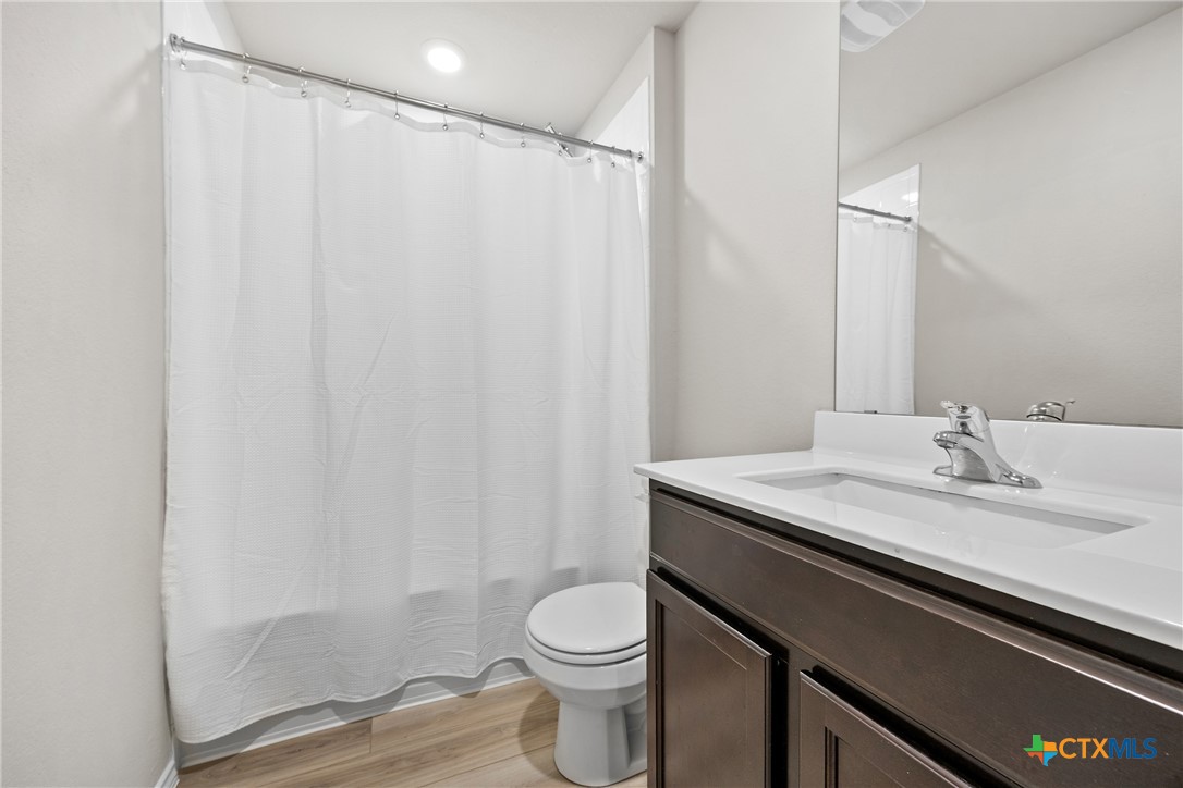 8903 Cantera Rdg Road Temple, TX 76502 - Photo 19 of 25 a bathroom with a granite countertop sink toilet and a mirror