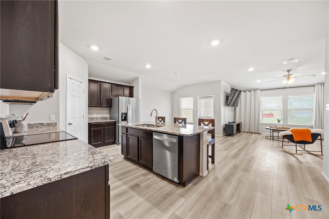 8903 Cantera Rdg Road Temple, TX 76502 - Photo 5 of 25 a kitchen with stainless steel appliances granite countertop a stove and a sink