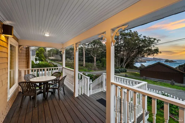 a balcony with wooden floor outdoor seating and city view