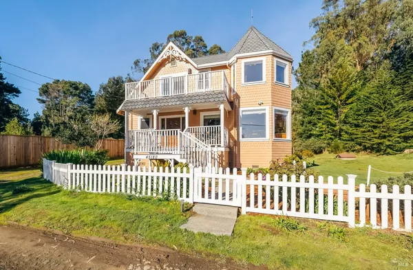 a front view of a house with a garden