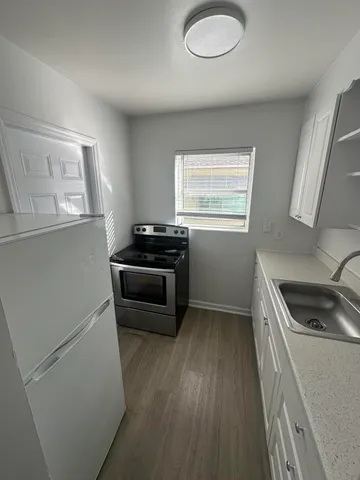 a kitchen with a refrigerator stove and sink