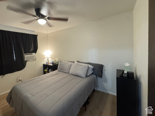 527 Palisade Drive Moab, UT 84532 - Photo 11 of 51 Bedroom with wood finished floors, a ceiling fan, and cooling unit