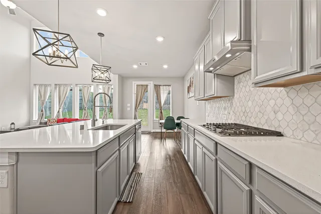 a kitchen with a stove a sink and a refrigerator