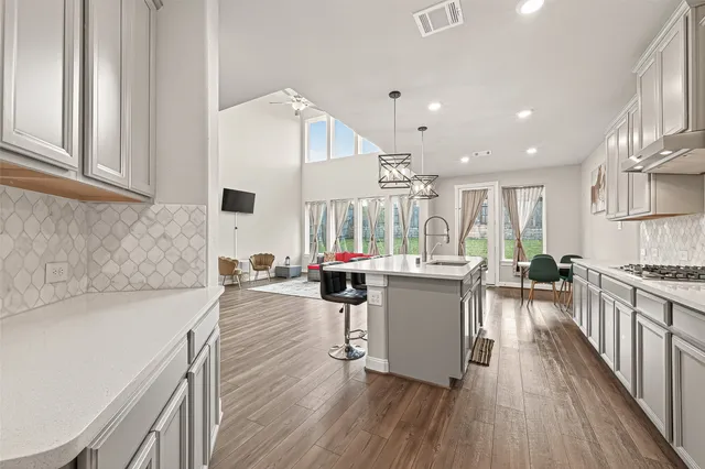 a kitchen with a sink a counter top space and stainless steel appliances