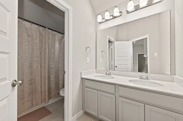 a bathroom with a double vanity sink mirror and double