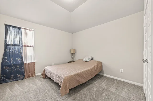 a bedroom with a bed and a chair