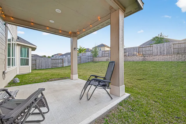 a large bed sitting in a spacious bedroom next to a window and a lamp