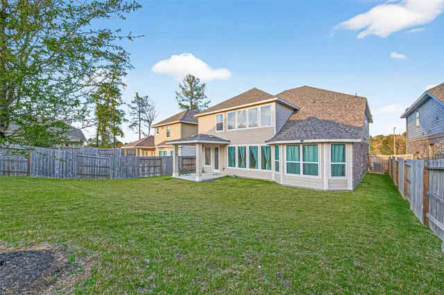 a view of a patio with a table chairs and a yard