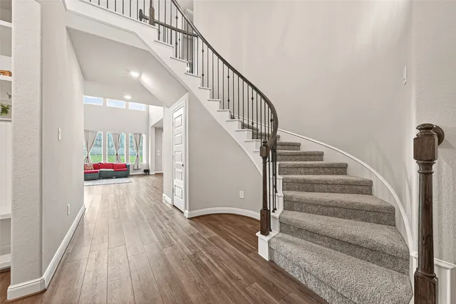 a view of entryway and hall with wooden floor