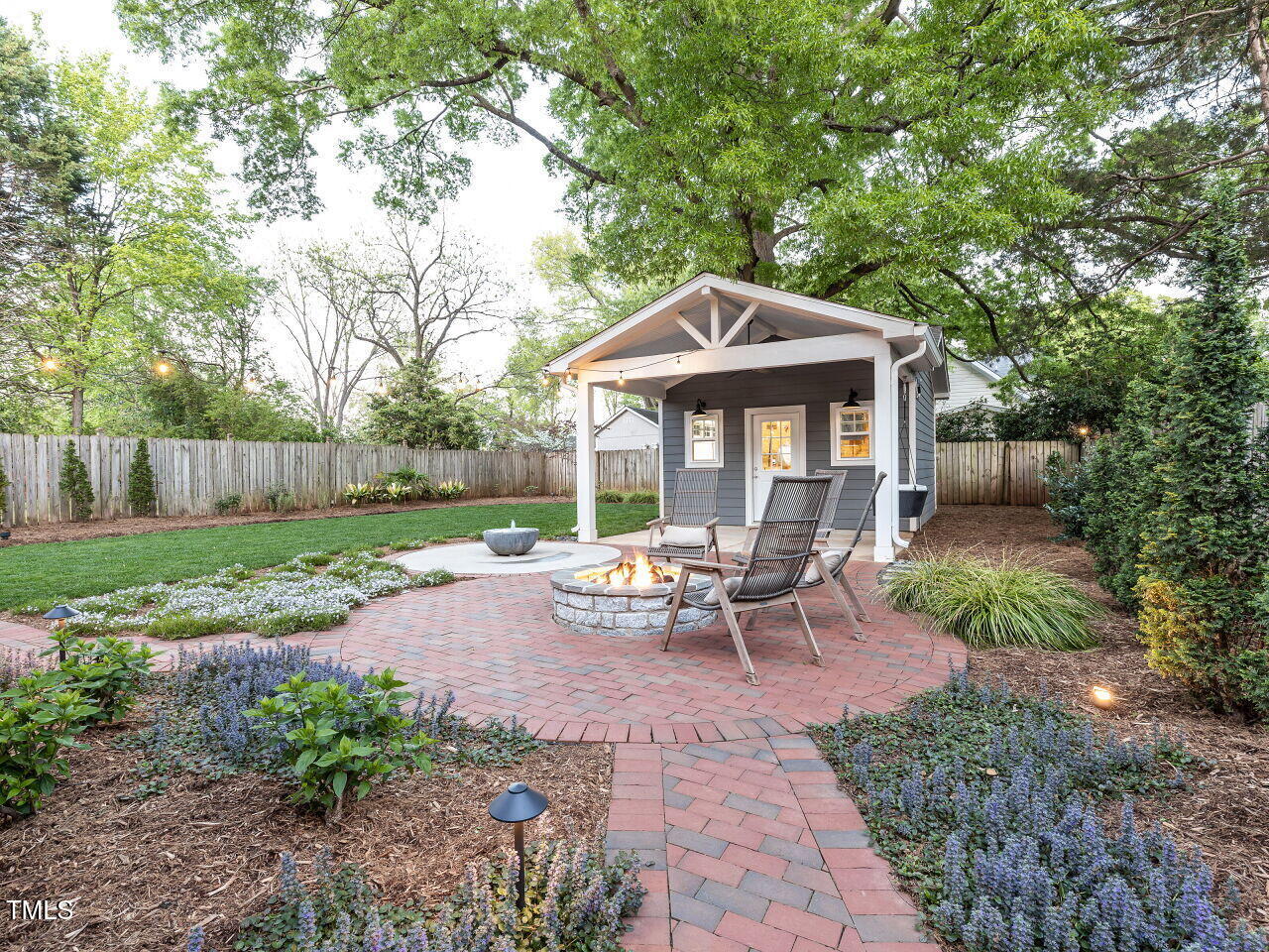 323 Morrison Avenue Raleigh, NC 27608 - Photo 54 of 98 a view of a patio with table and chairs under an umbrella