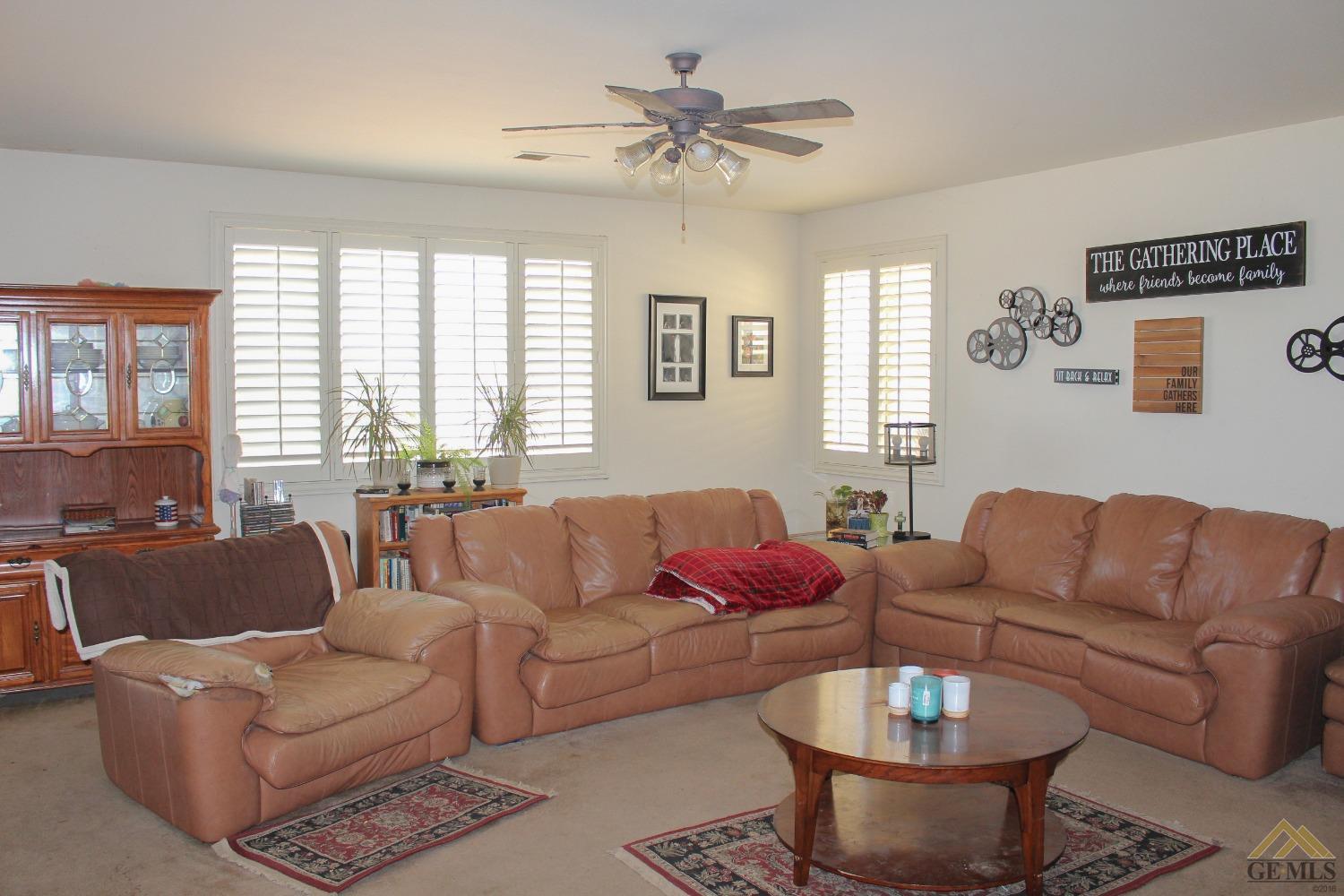 Undisclosed Address Bakersfield, CA 93311 - Photo 4 of 10 a living room with furniture a large window and a chandelier