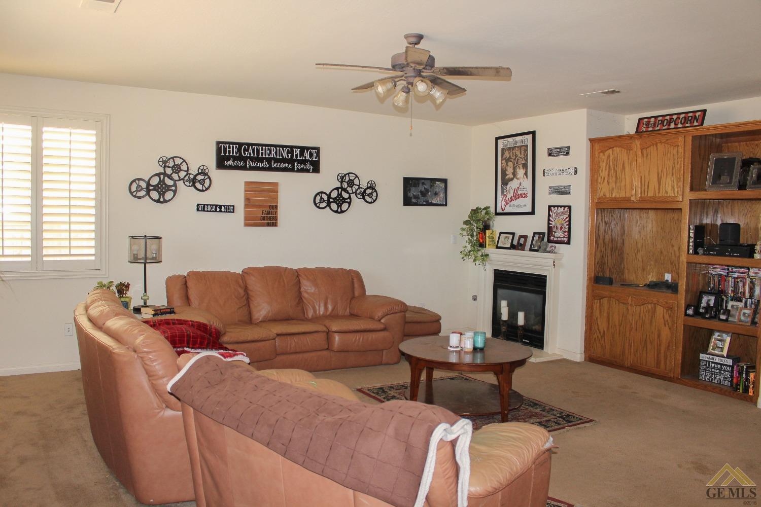 Undisclosed Address Bakersfield, CA 93311 - Photo 5 of 10 a living room with furniture and a fireplace