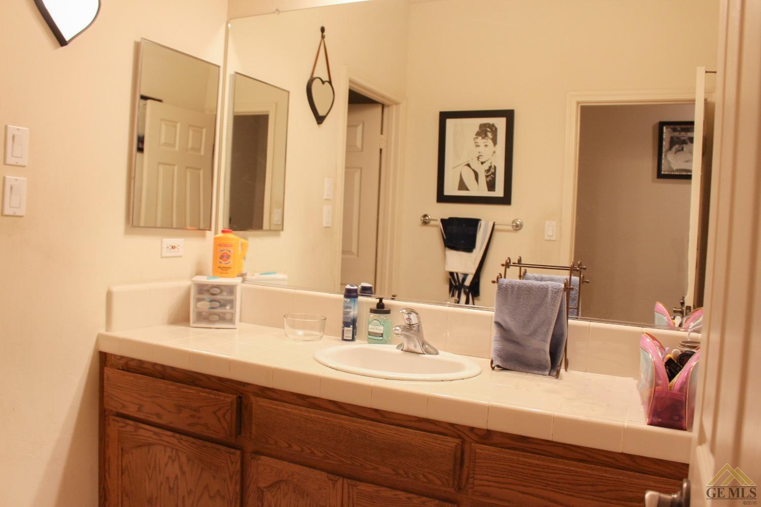 Undisclosed Address Bakersfield, CA 93311 - Photo 7 of 10 a bathroom with a sink and a mirror