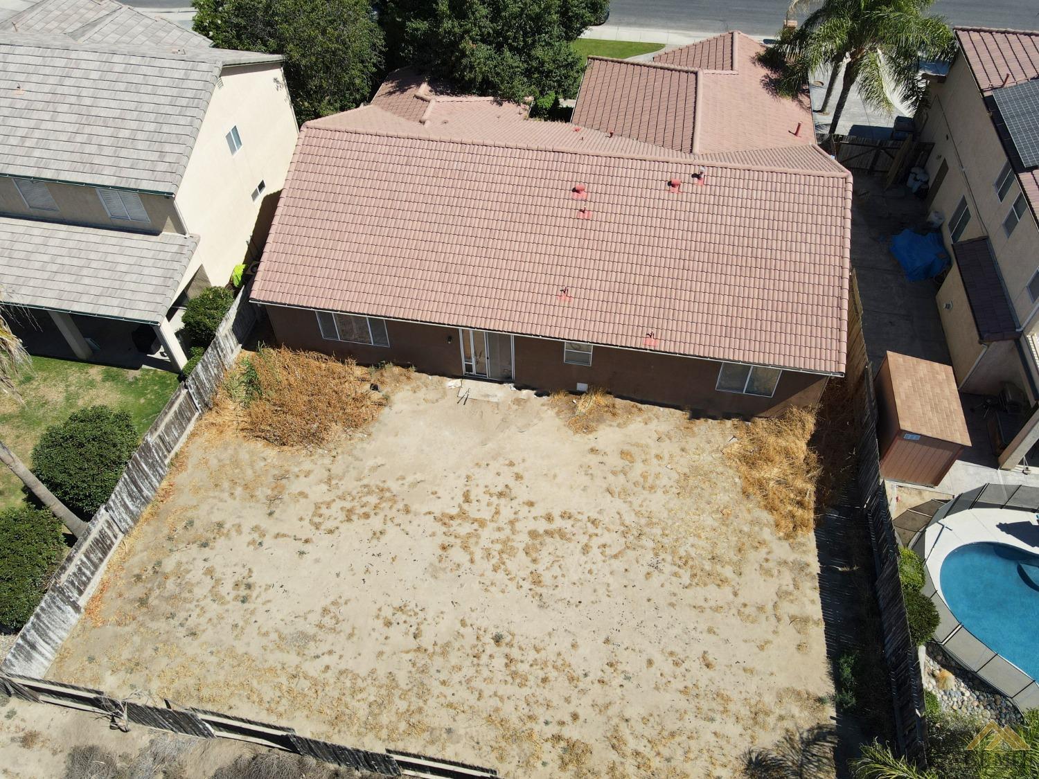Undisclosed Address Bakersfield, CA 93311 - Photo 8 of 10 a view of a backyard with a wooden fence