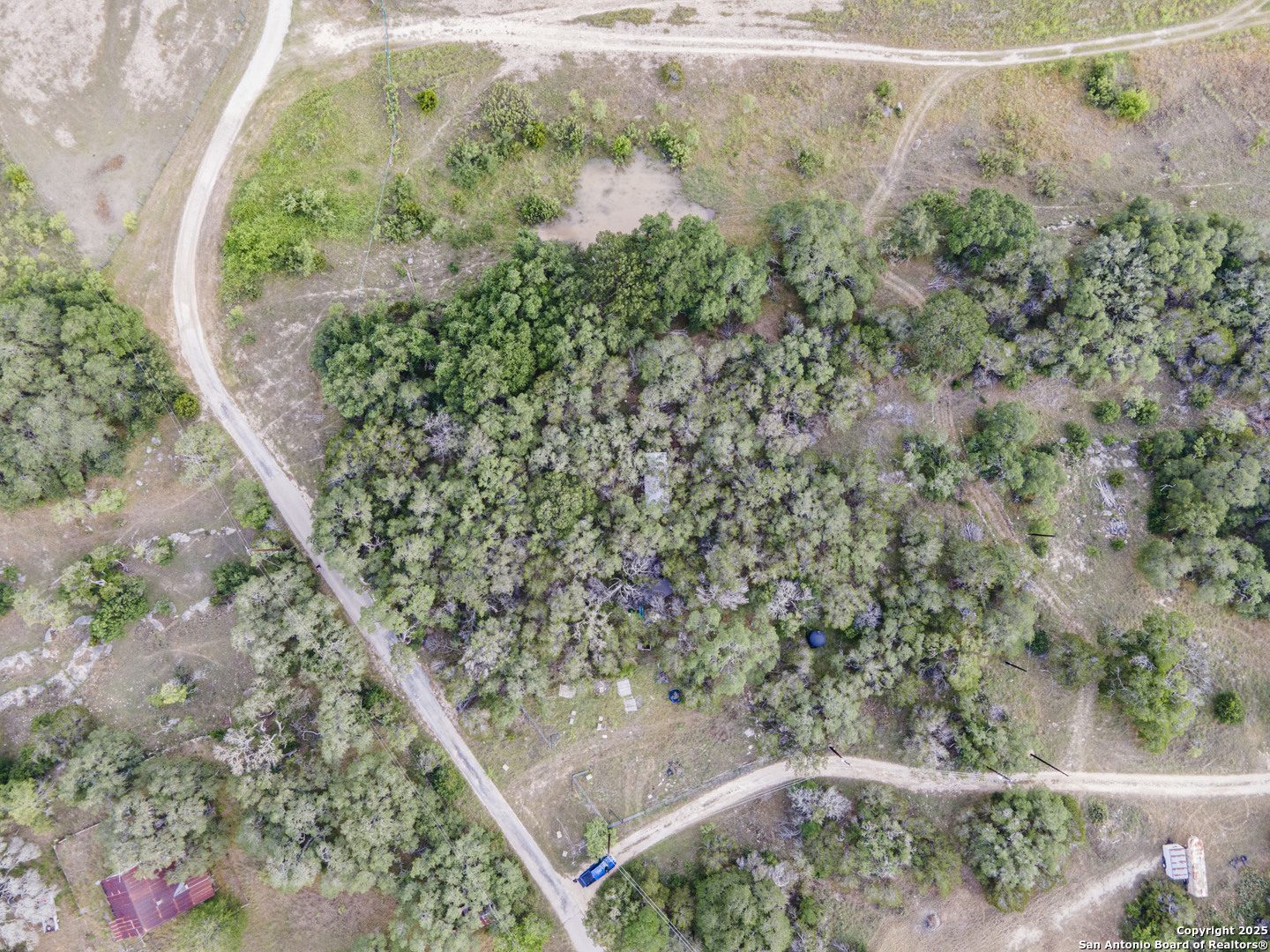 296 Recreation Spring Branch, TX 78070 - Photo 7 of 10 an aerial view of a house with a yard and garden