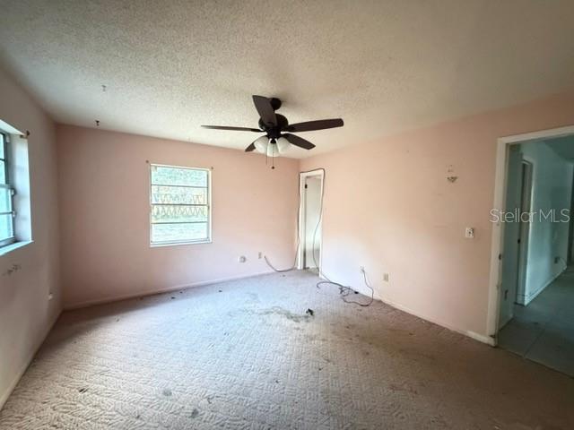 2871 West Albatross Road Avon Park, FL 33825 - Photo 4 of 11 an empty room with a ceiling fan and window
