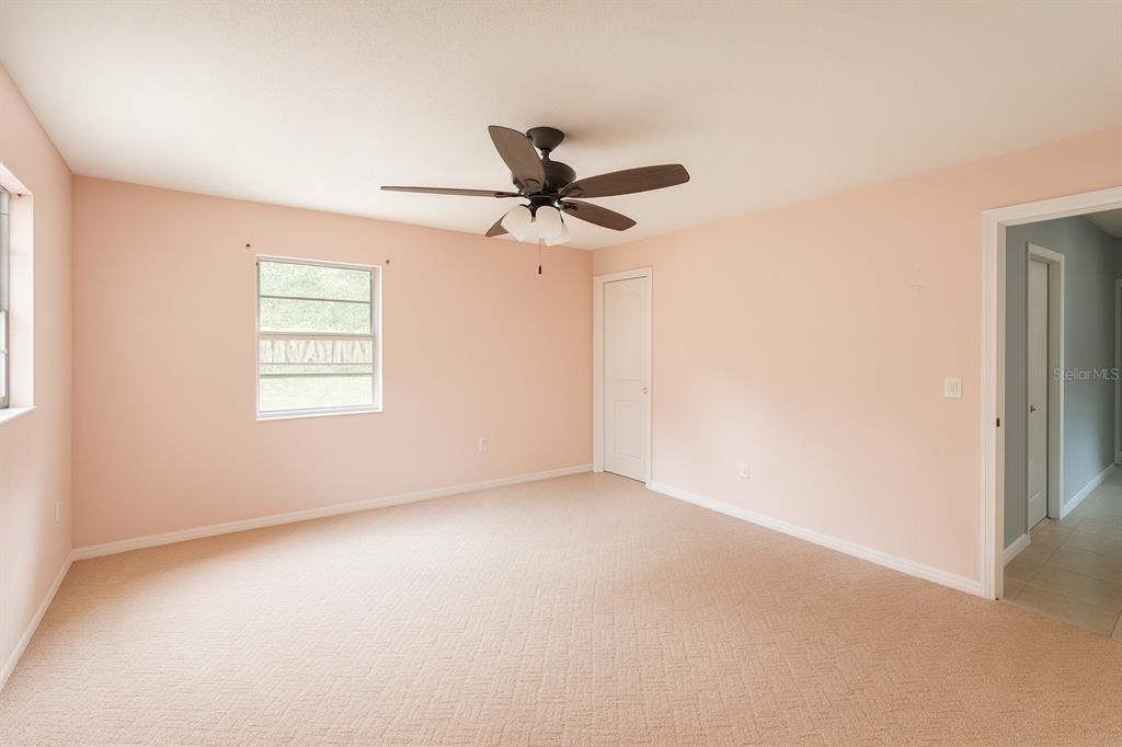 2871 West Albatross Road Avon Park, FL 33825 - Photo 5 of 11 an empty room with windows and fan