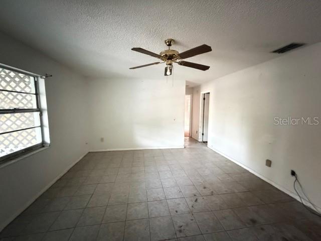 2871 West Albatross Road Avon Park, FL 33825 - Photo 6 of 11 en empty room with windows and fan
