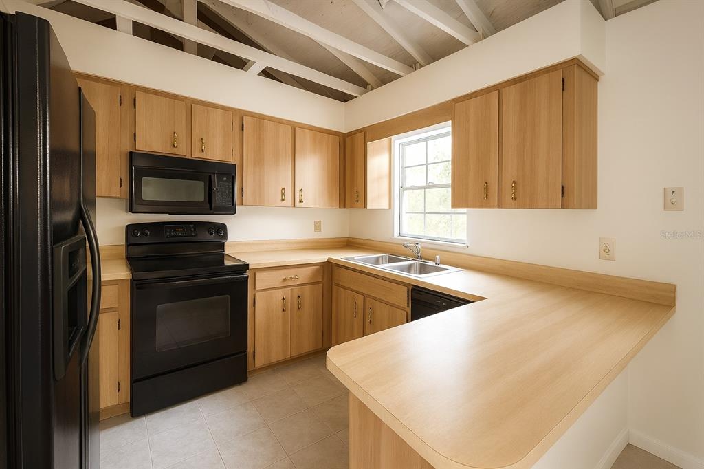 2871 West Albatross Road Avon Park, FL 33825 - Photo 9 of 11 a kitchen with a refrigerator stove and microwave