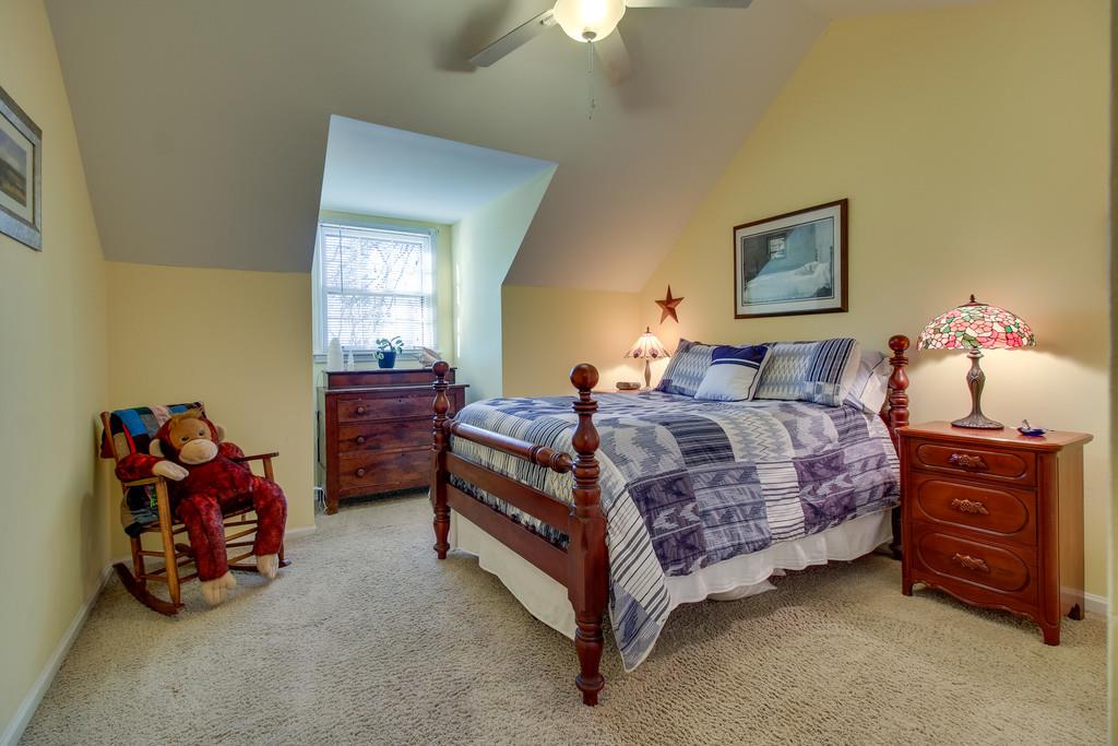 127 Baltusrol Road Franklin, TN 37069 - Photo 13 of 23 a bedroom with a bed and a chandelier