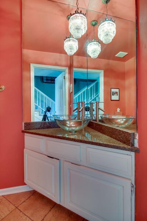 127 Baltusrol Road Franklin, TN 37069 - Photo 18 of 23 a bathroom with a granite countertop sink and a large mirror