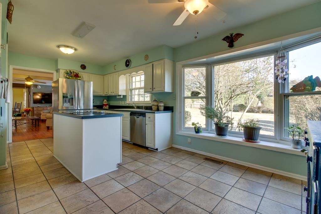 127 Baltusrol Road Franklin, TN 37069 - Photo 7 of 23 a kitchen with stainless steel appliances granite countertop a stove and a refrigerator