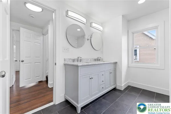 a bathroom with a granite countertop sink a mirror and a