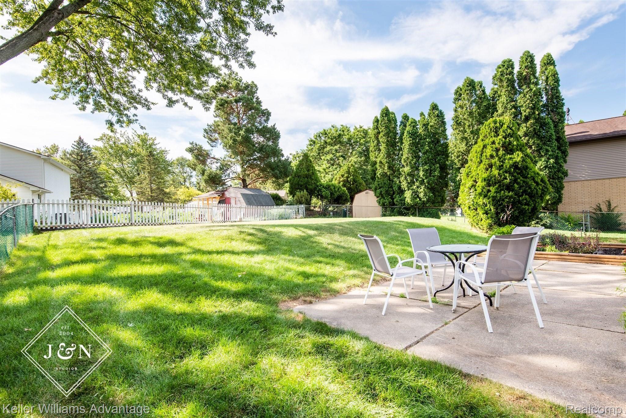 42209 Park Ridge Road Novi, MI 48375 - Photo 2 of 17 Relax in the big fenced in back yard with Patio and Garden