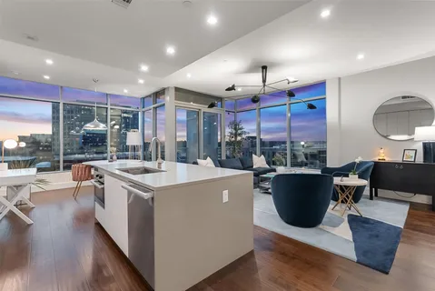 a open kitchen with stainless steel appliances granite countertop a sink a stove and a refrigerator