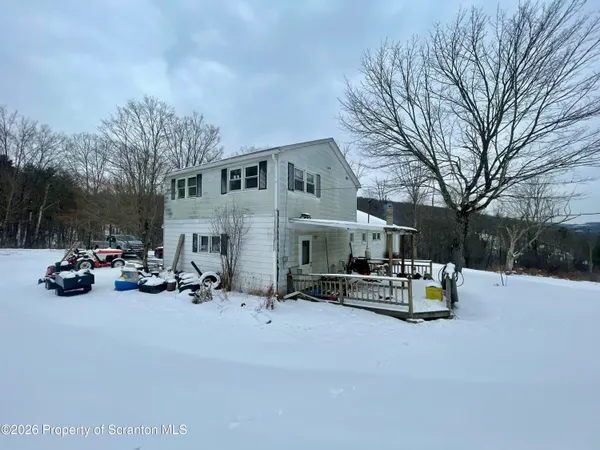 a view of the patio with a table and chairs under an umbrella