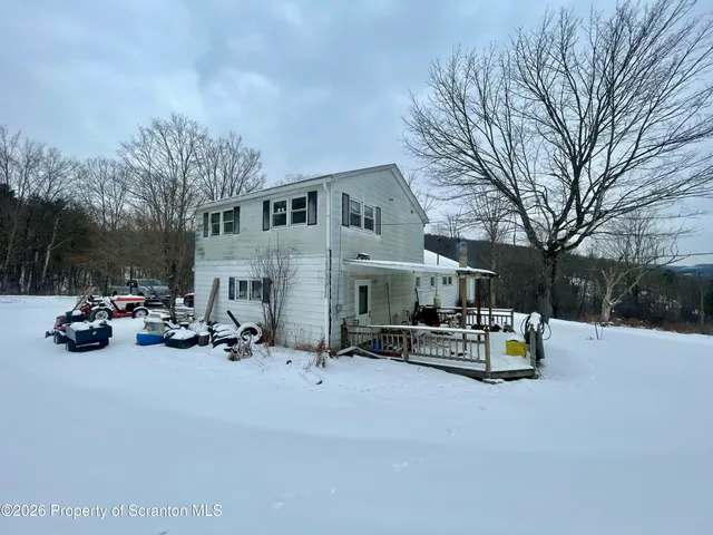 a view of the patio with a table and chairs under an umbrella
