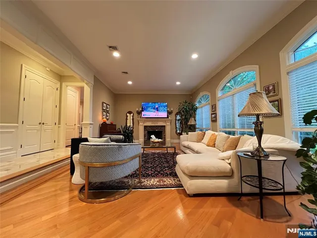 a living room with fireplace furniture and a large window