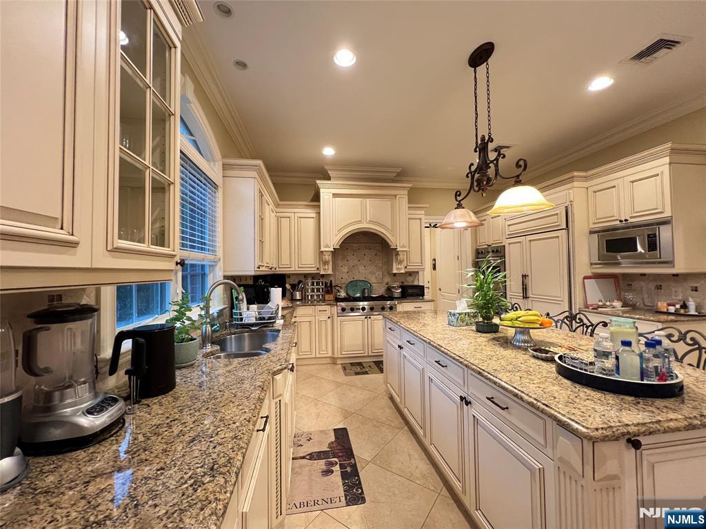 22 Reiner Place Englewood Cliffs, NJ 07632 - Photo 13 of 37 a kitchen with stainless steel appliances kitchen island granite countertop a sink and cabinets