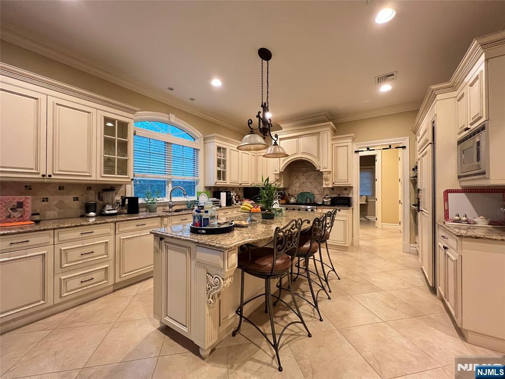 22 Reiner Place Englewood Cliffs, NJ 07632 - Photo 14 of 37 a kitchen with a sink dining table and chairs