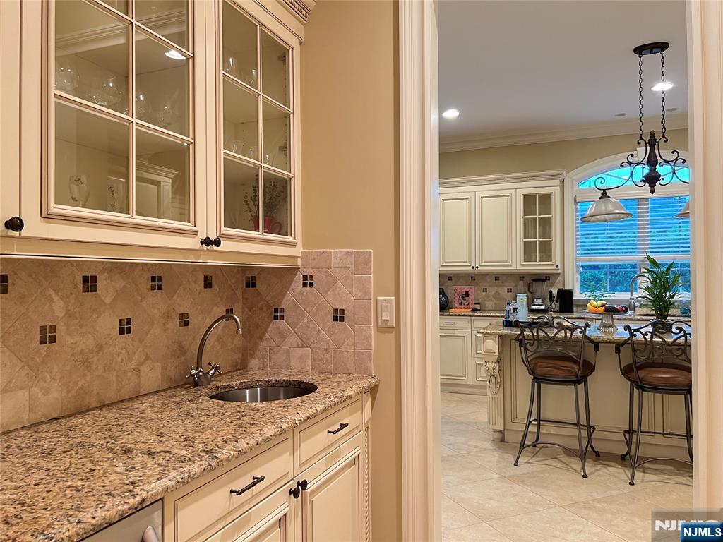 22 Reiner Place Englewood Cliffs, NJ 07632 - Photo 16 of 37 a kitchen with a granite countertop sink stove and white cabinets