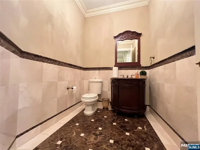 a bathroom with a toilet a sink and mirror