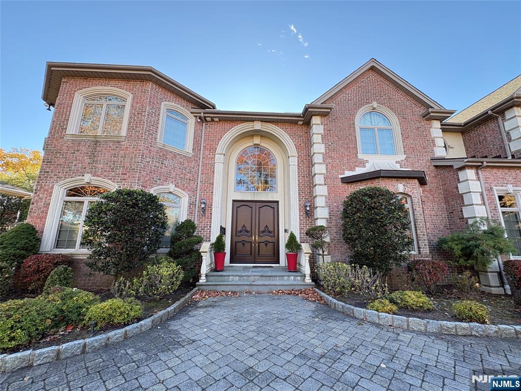 22 Reiner Place Englewood Cliffs, NJ 07632 - Photo 2 of 37 a front view of a house with a garden