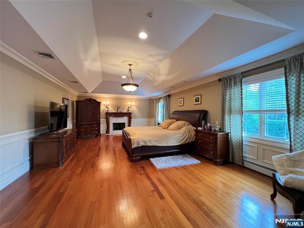 22 Reiner Place Englewood Cliffs, NJ 07632 - Photo 22 of 37 a spacious bedroom with a bed and a flat screen tv