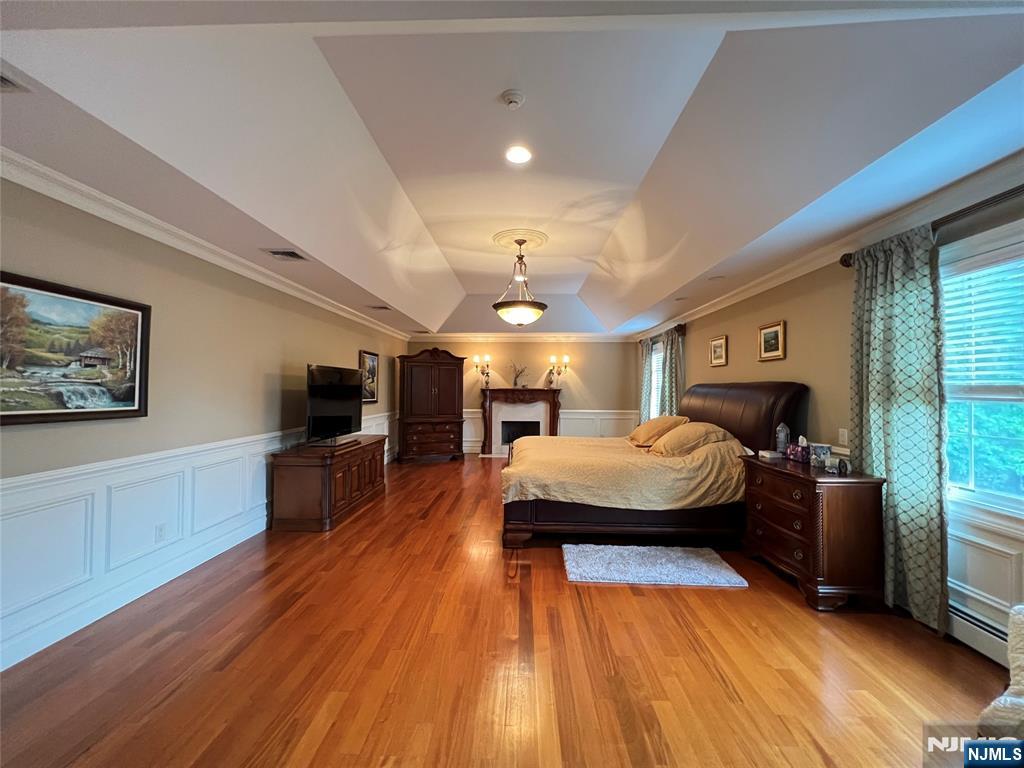 22 Reiner Place Englewood Cliffs, NJ 07632 - Photo 27 of 37 a spacious bedroom with a bed and a flat screen tv