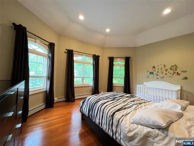 a bedroom with a large bed and a large window