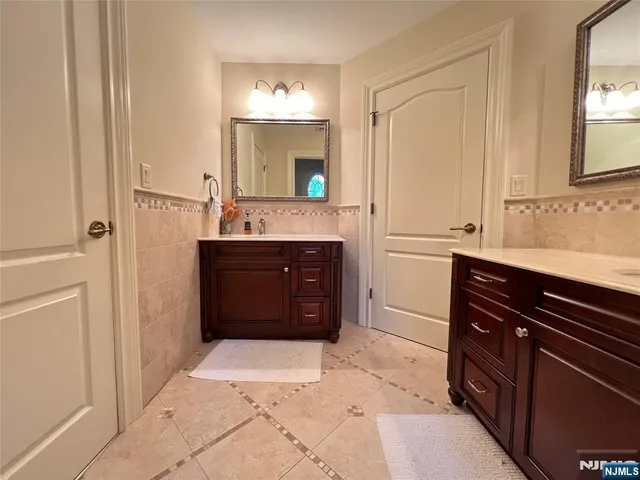 a spacious bathroom with a sink and a mirror