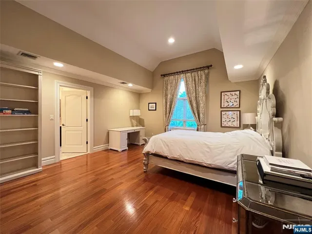 a bed room with a bed and a television