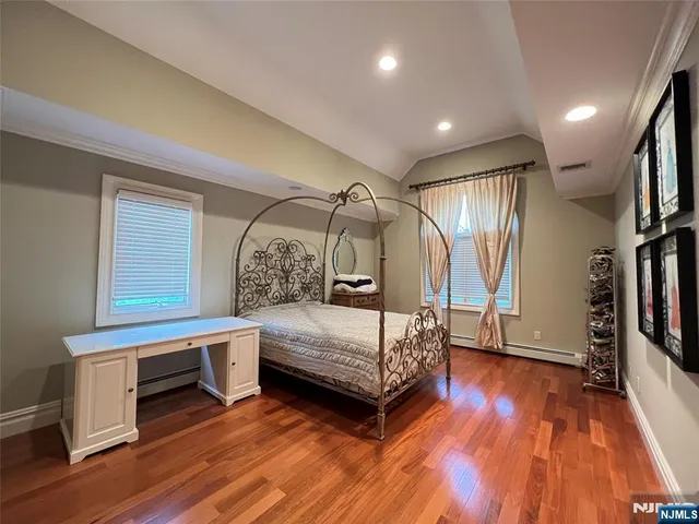 a bedroom with furniture and a wooden floor