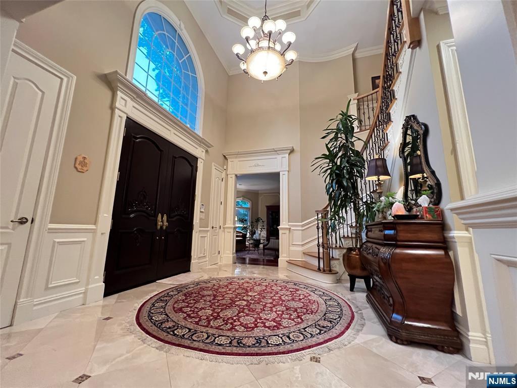 22 Reiner Place Englewood Cliffs, NJ 07632 - Photo 4 of 37 a view of a livingroom with a fireplace wooden floor and a chandelier