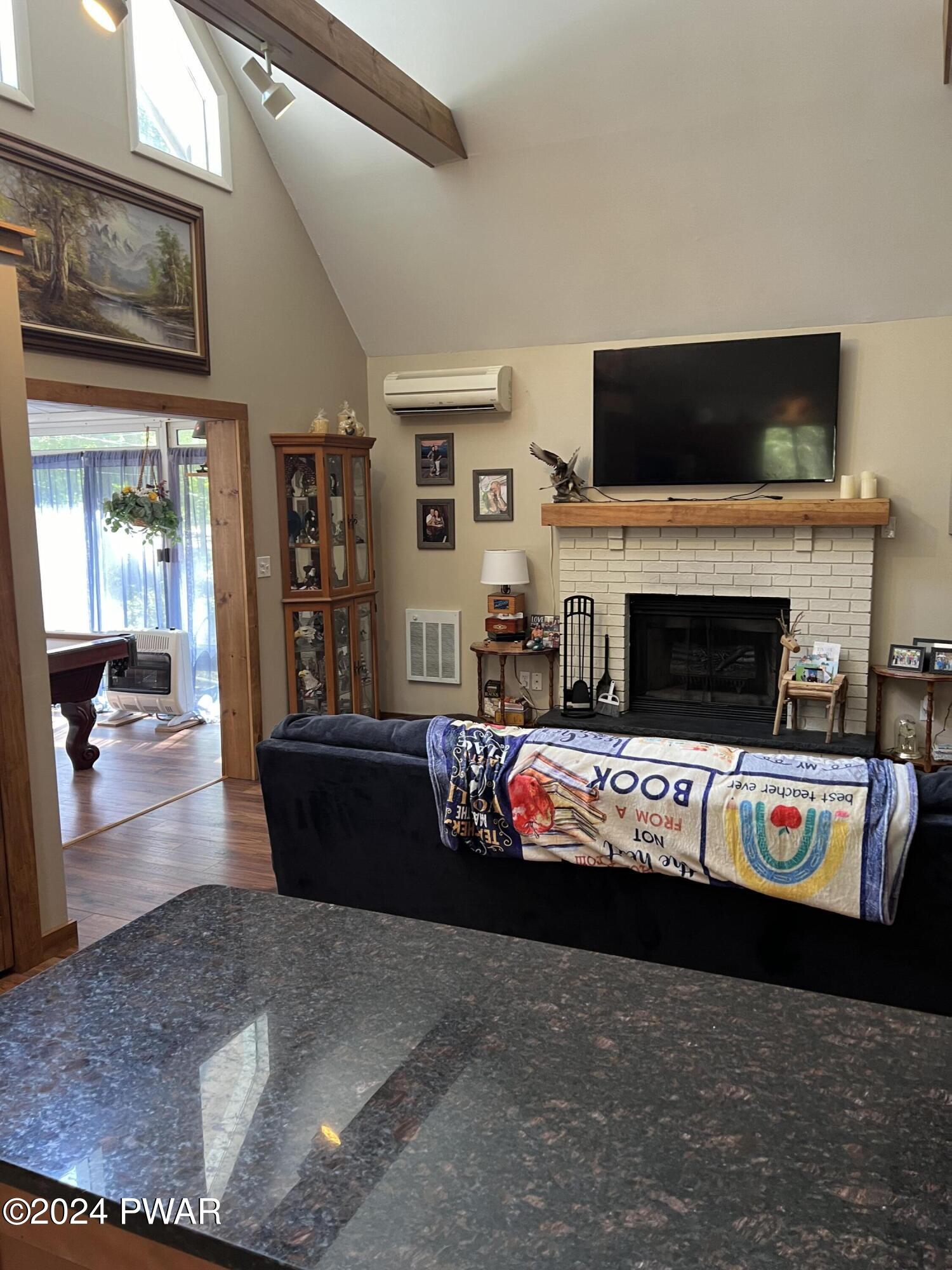 207 Maple Ridge Drive Hawley, PA 18428 - Photo 11 of 27 a living room with furniture and a flat screen tv