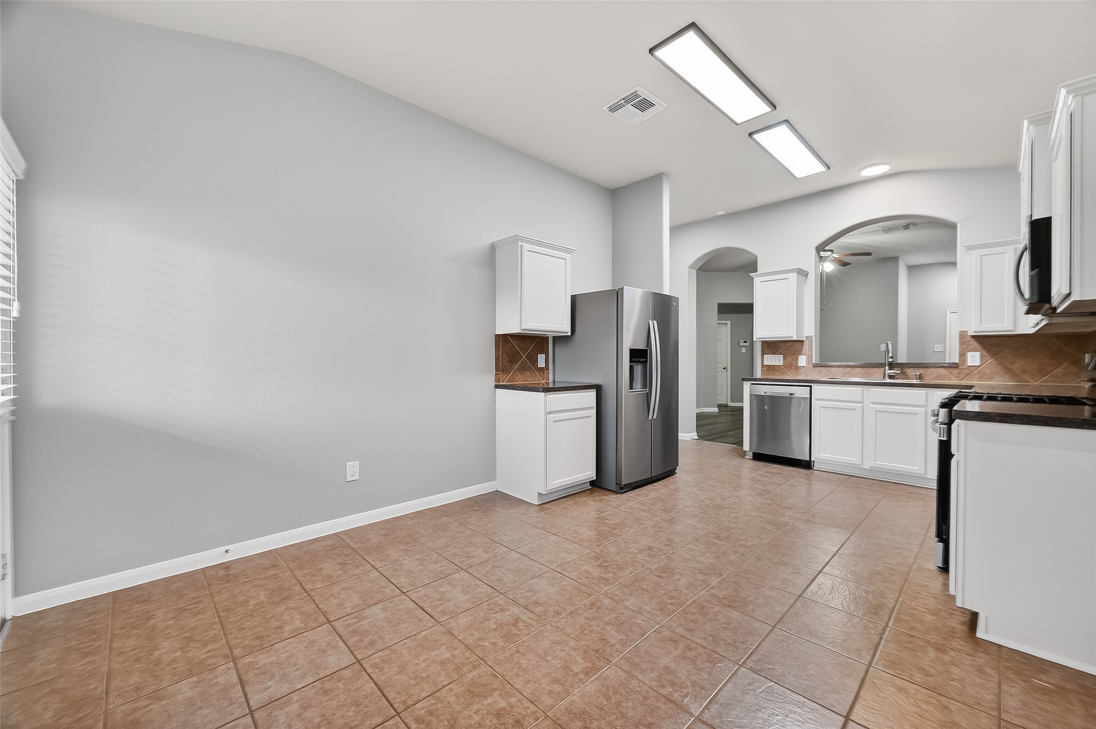 22419 Toronado Ridge Lane Porter, TX 77365 - Photo 13 of 35 a kitchen with white cabinets and appliances