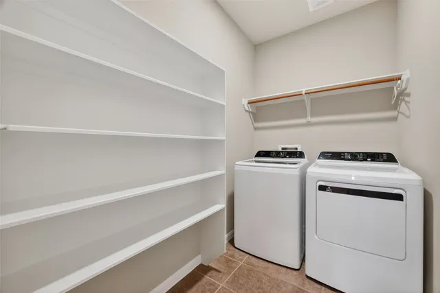 a view of storage and utility room with washer and dryer