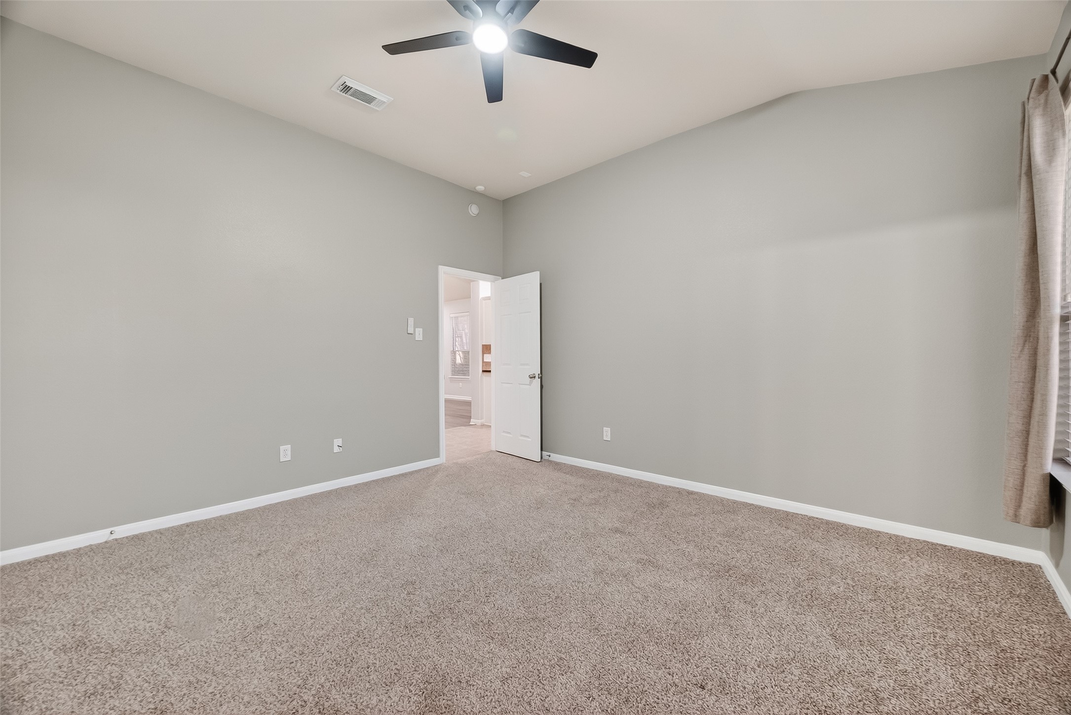 22419 Toronado Ridge Lane Porter, TX 77365 - Photo 24 of 35 an empty room with a empty space and a ceiling fan